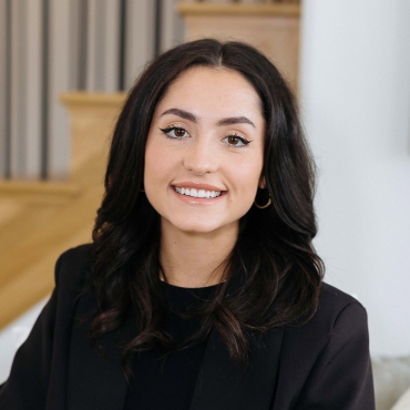 real estate agent natalie blasko smiles while looking towards the camera