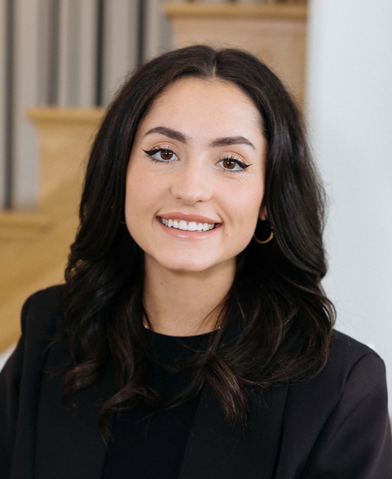 real estate agent natalie blasko smiles while looking towards the camera